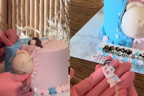 Uroczy tort na baby shower z figurką ciężarnej kobiety. Dekoracja w kolorach różowym i niebieskim, z napisem "Please us a sec".