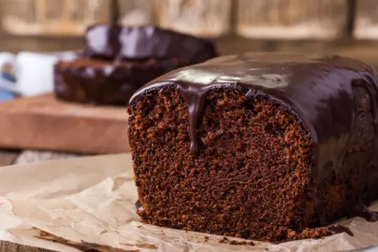 Wilgotna babka jogurtowa z polewą czekoladową, kusząca bogactwem smaku i aromatu.