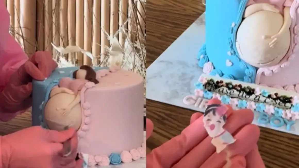 Uroczy tort na baby shower z figurką ciężarnej kobiety. Dekoracja w kolorach różowym i niebieskim, z napisem "Please us a sec".